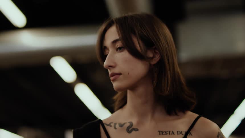 A beautiful tattooed woman walking on a store