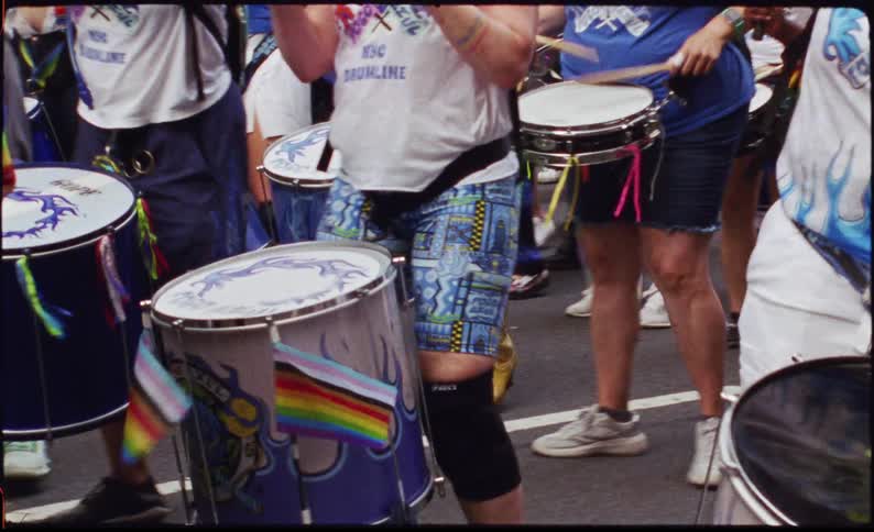 A group of people playing drums in a parade