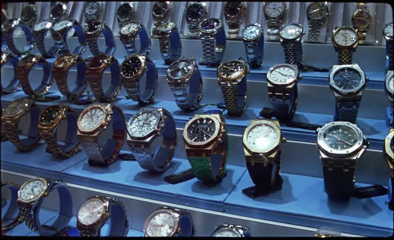 Wrist watches displayed for sale arranged row by row