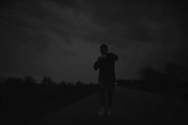 Silhouette of a boxer running through the countryside