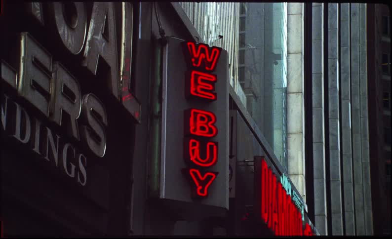 Facade of a commercial establishment in a metropolis with neon letters