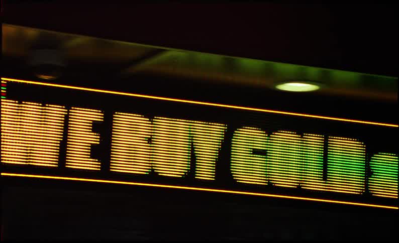 Chaotic close up of a digital sign on the window of a store