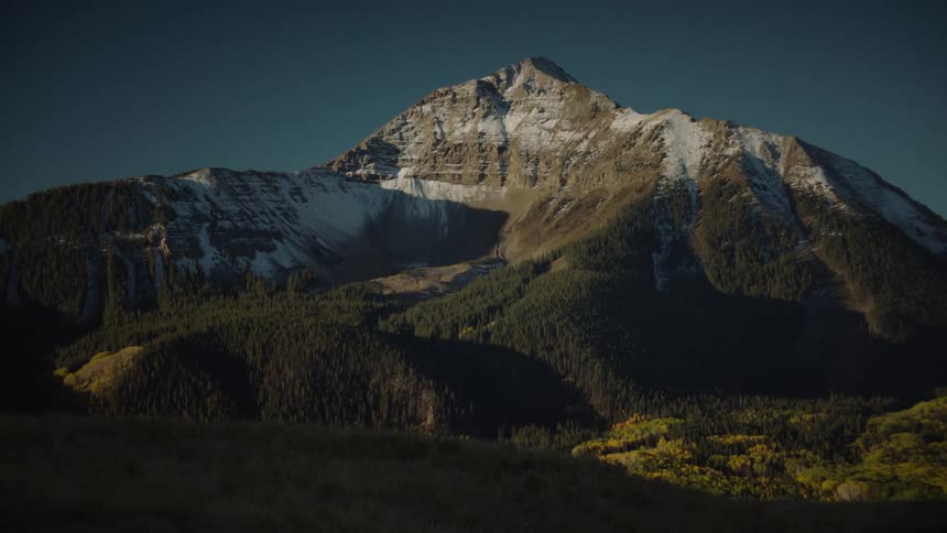 A snowcapped mountain peak under a clear blue sky