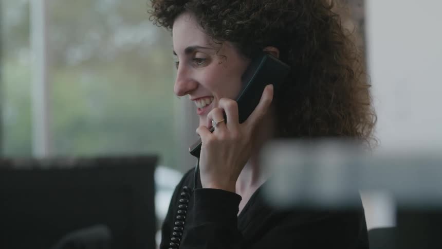 A woman on a phone call at the office