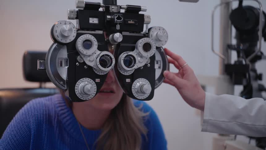 A person undergoing an eye examination with a phoropter