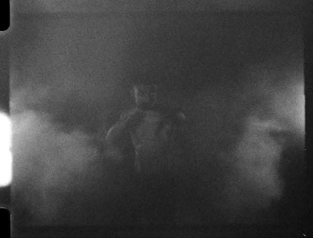 Black and white footage of a boxer surrounded by smoke caught on vintage film