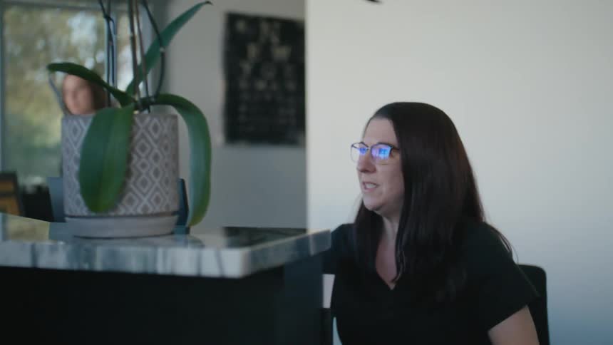 Woman talking to the receptionist at an establishment