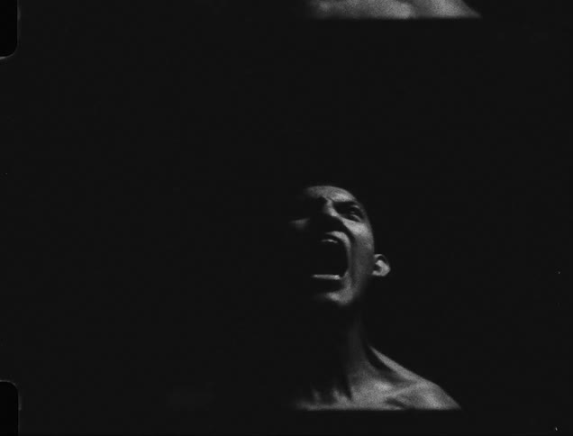 A man screams in the dark room