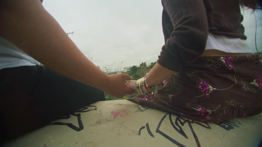 Young couple holding hands outdoors