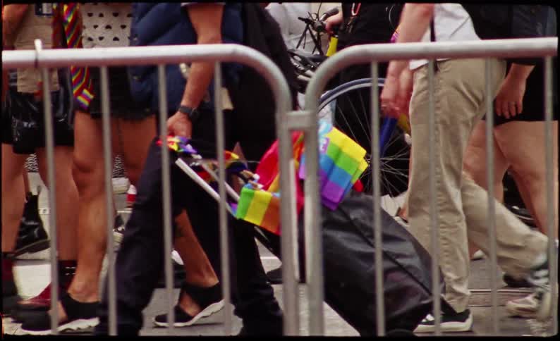 Legs of people walking in the same direction through the streets of a metropolis demonstrating in favor of homosexuality