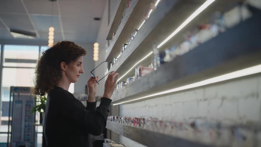 A woman is looking at different glasses
