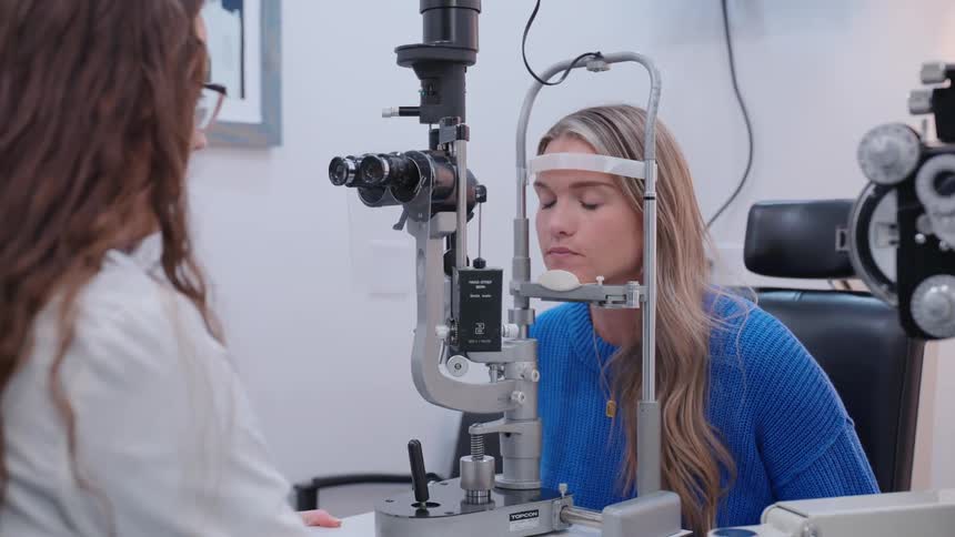 An ophthalmologist gives a patient an eye test