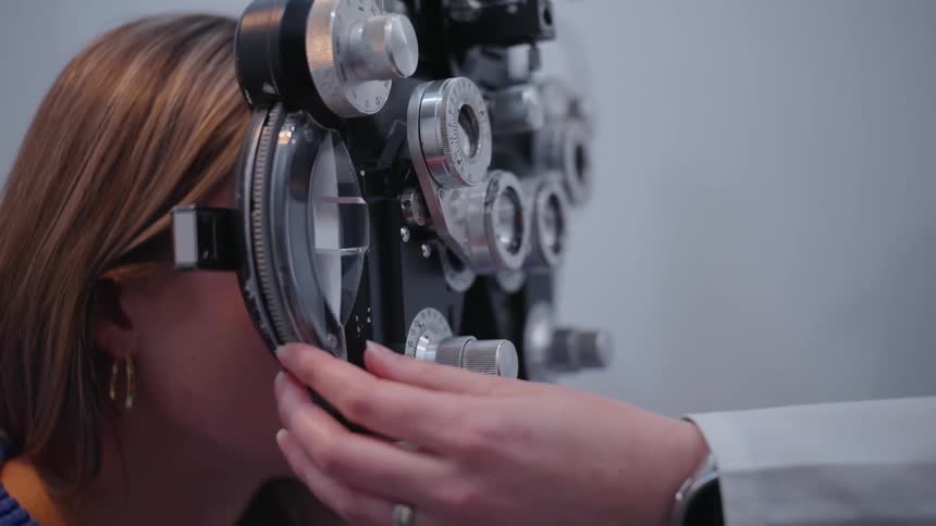 An optometrist gives a patient an eye exam