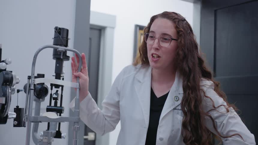 The optometrist speaks with a patient
