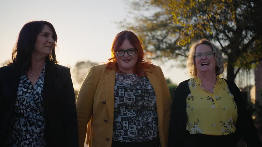 A group of friends walking on a neighborhood at sunset