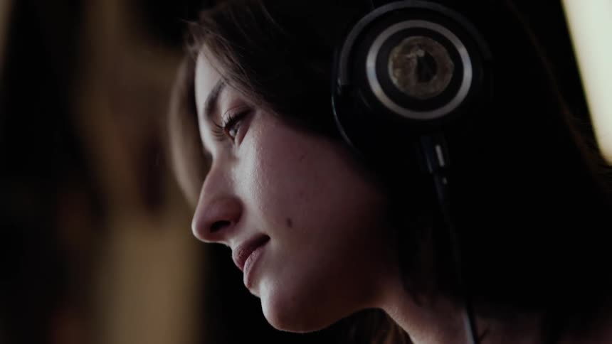 A woman is listening to music on her headphones