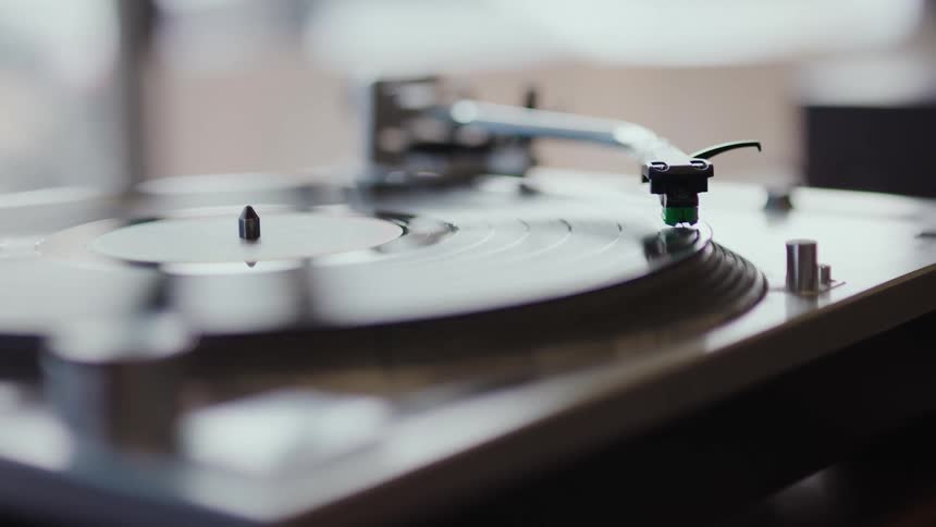A vinyl record playing on a retro turntable player