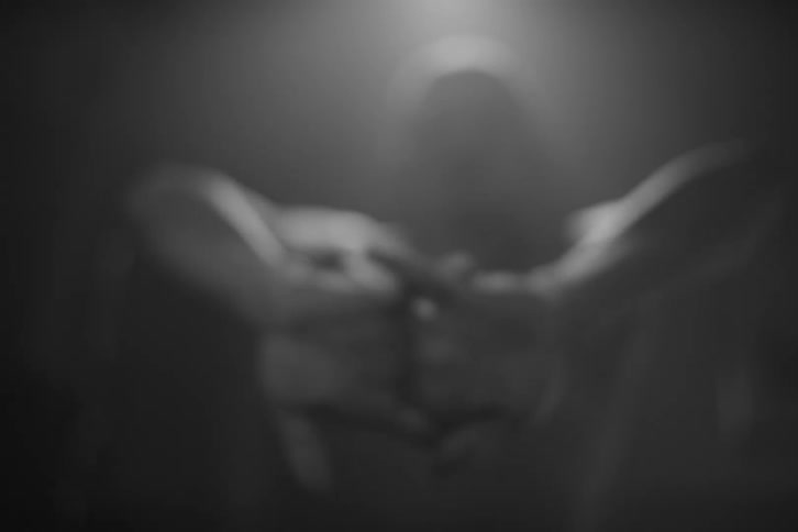 Muscular shirtless man stretches his hands