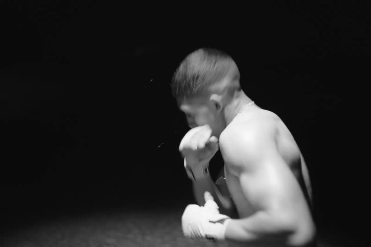 Boxer practicing outdoors under a spotlight at night