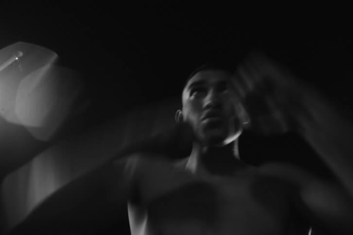 A man is boxing in the dark
