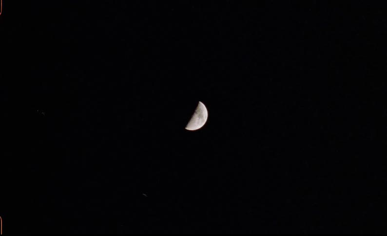 Dark sky at night with a half moon