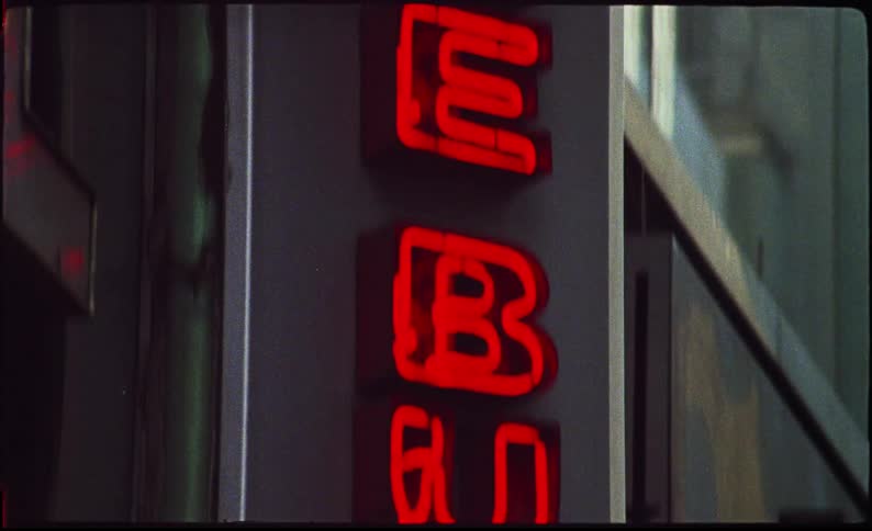 A red neon we buy sign on the side of a building