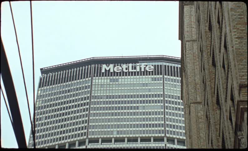 Commercial skyscraper in a metropolis all mirrored against a cloudy day