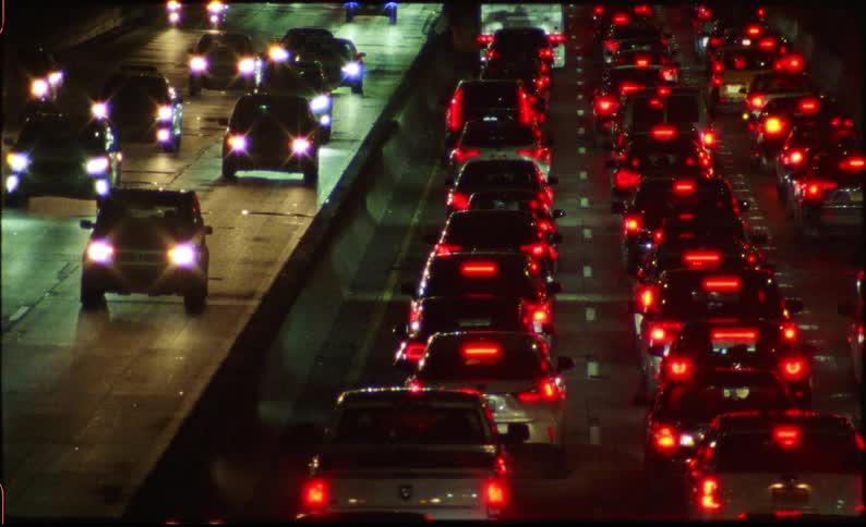 Highway with twoway vehicle traffic seen at night