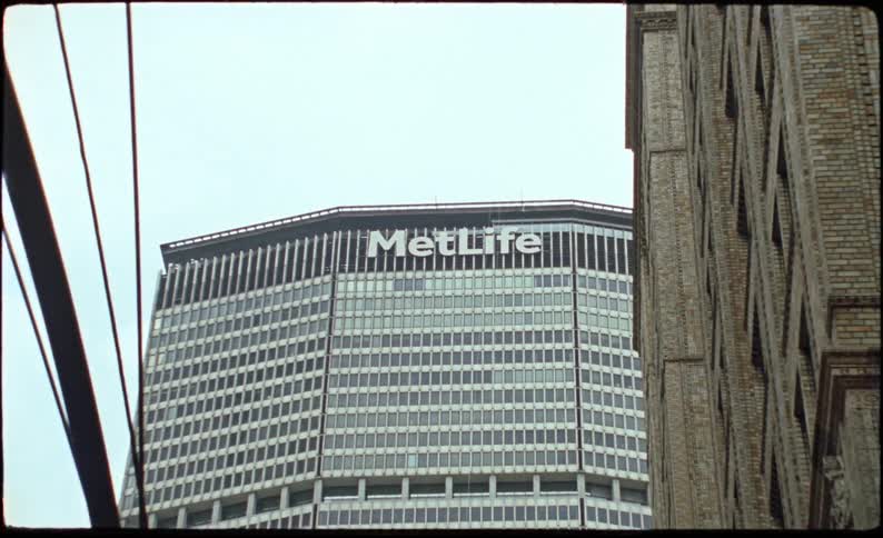Commercial mirrored skyscraper in a metropolis on a cloudy day