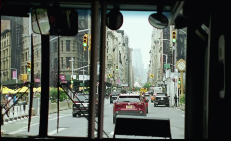 Interior view of a public bus moving along a street with vehicular traffic in the metropolis