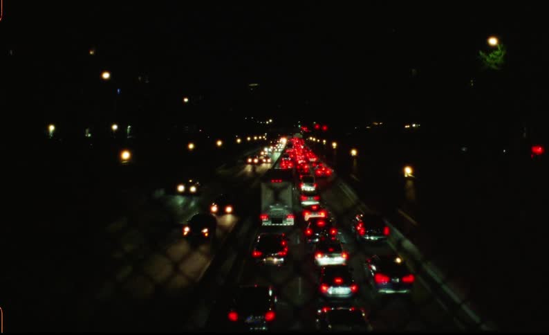 Two streets in different directions at night with vehicle traffic