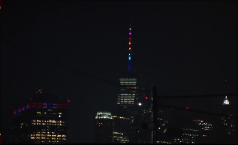A tall antenna on a building flashes with lights