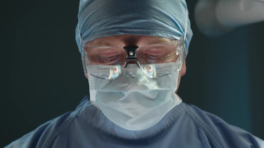 Male surgeon in operating room speaks during an operation