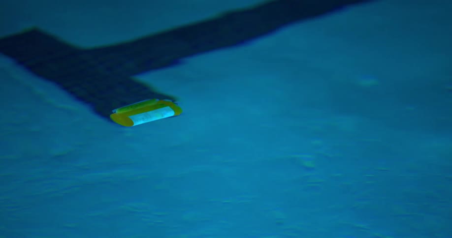Abstract yellow capsule floating in the pool