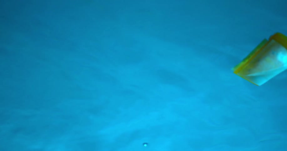 Yellow medicine bottle floating in the pool