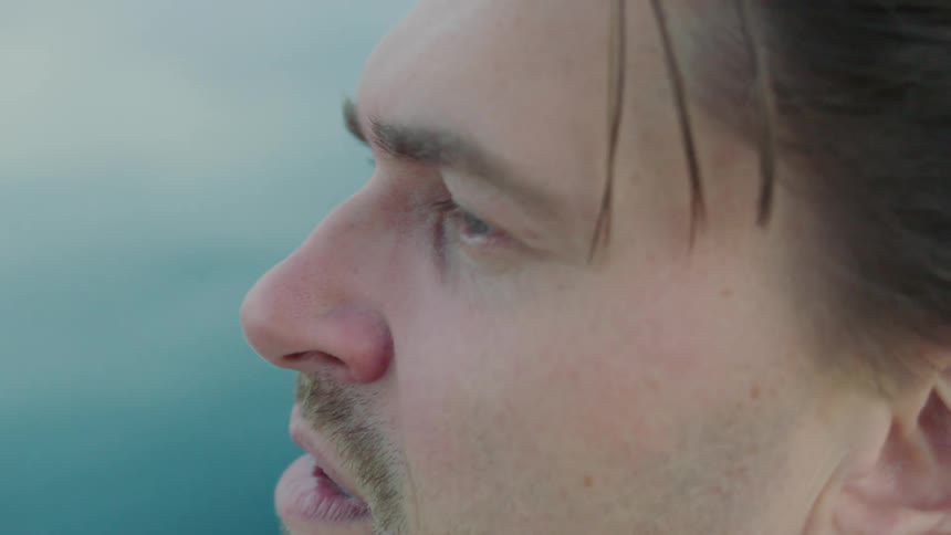 A man is looking out over the water