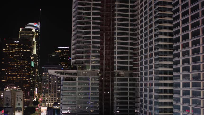 Panorama of skyscrapers illuminated at night in a metropolis