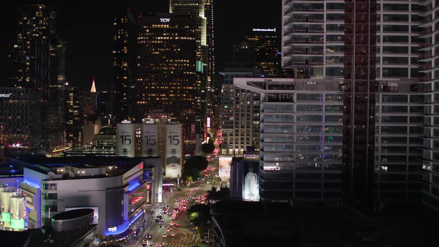 Panorama of intersections with vehicle traffic seen at night in a metropolis with skyscrapers