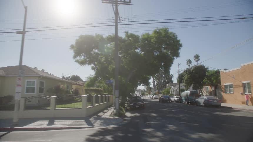 Cars are parked all along the road