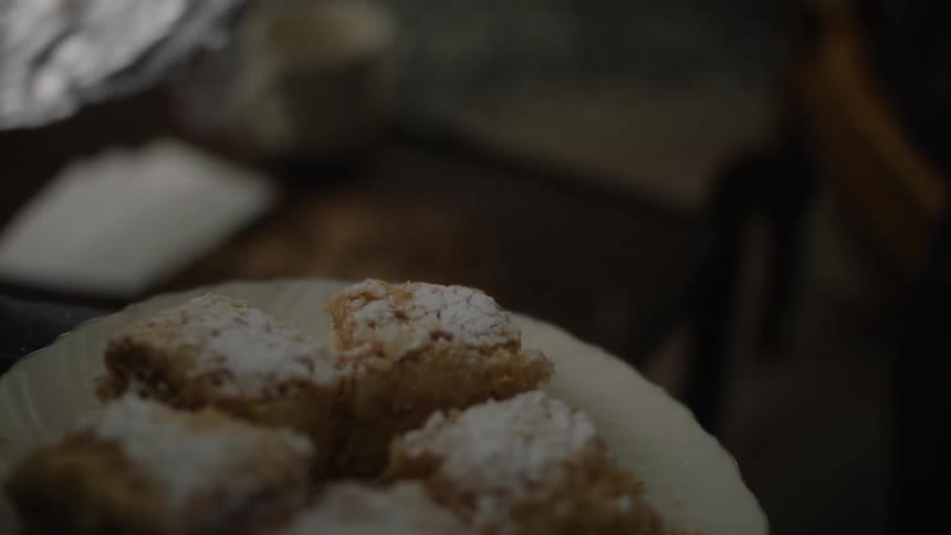 A person carries a plate of pastries