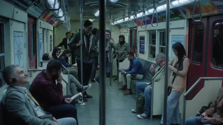 As a man on a subway gets up from his seat and walks away everyone else around him laughs