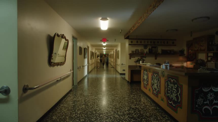 Corridor with a man in a suit passing by and other people in the background