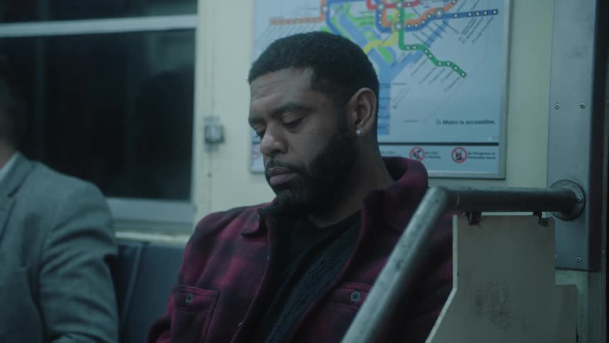 A man is resting as he rides on the train