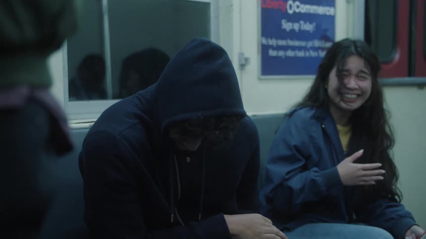 Two friends sitting on a bench and laughing a lot