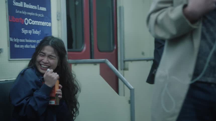 A group of people share a laugh on a subway