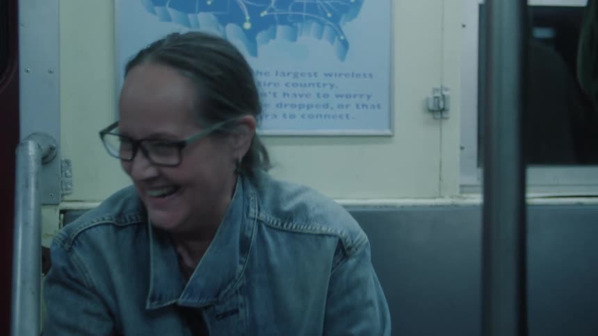 A woman is laughing in the train