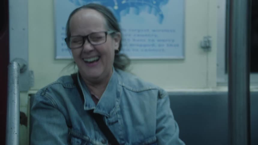 People laugh hard while traveling by subway