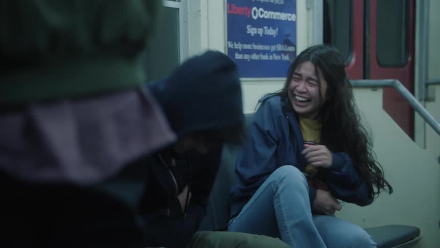 Several people are in a subway and they are laughing a lot