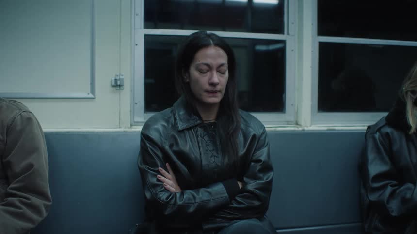 Sad woman in a black leather jacket travels by train crying