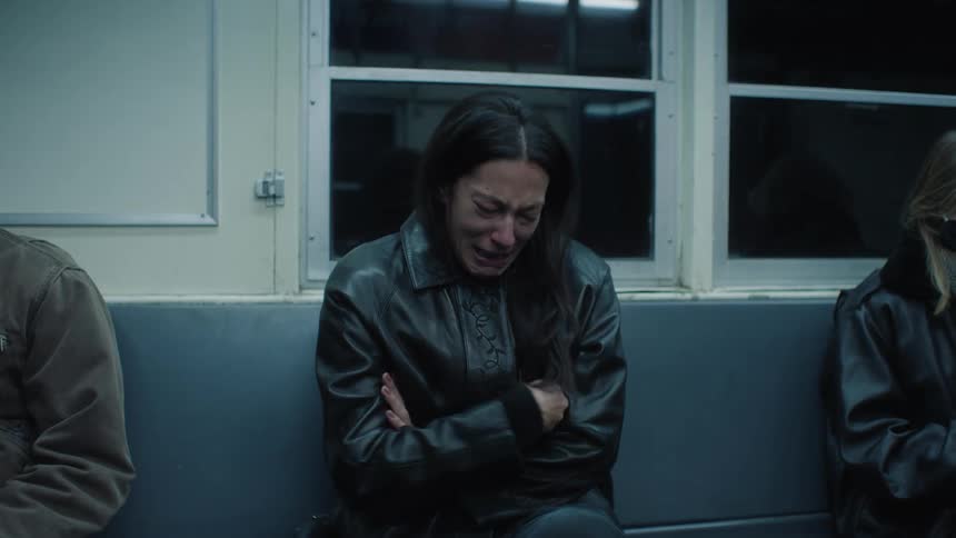 A woman is sobbing on the train